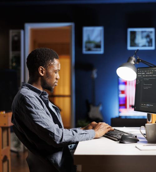 Male programmer working on developing new html script, typing binary code on terminal window. Young web developer does debugging work with coding language, database internet security.